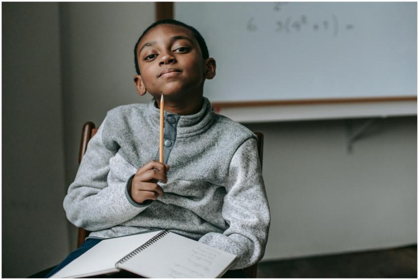 Cute little black boy wearing fleece sweater sitti