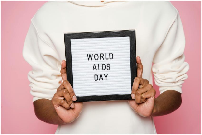 A person holding a sign with World AIDS Day messag