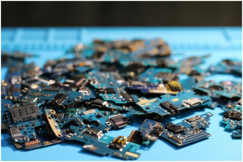 Pile of disassembled circuit boards on a blue surf