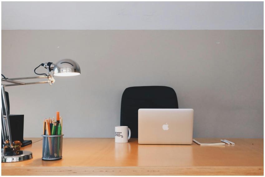 A tidy minimalist office setup featuring a laptop,