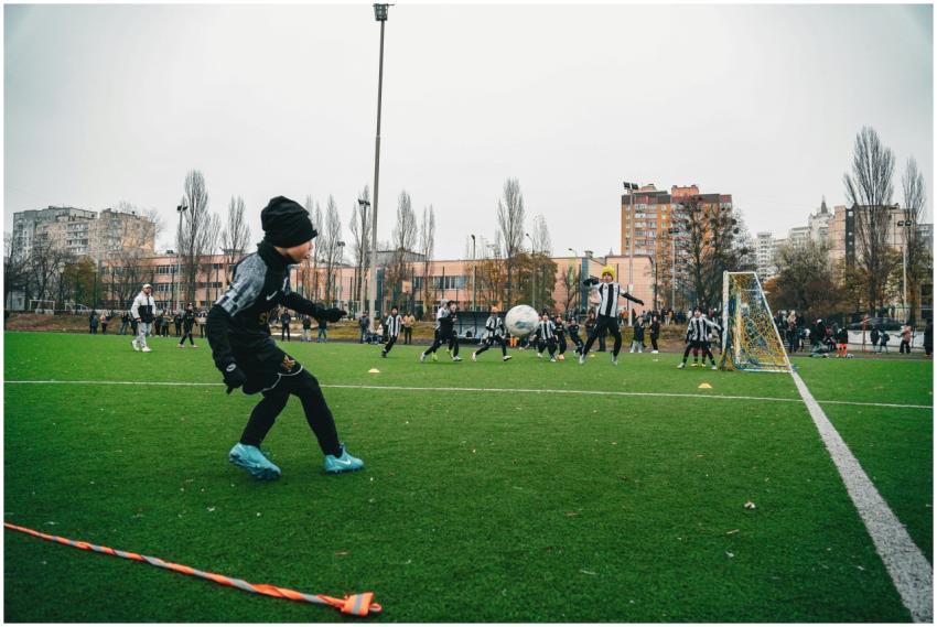 Kids playing soccer on an outdoor field in Kyiv, U