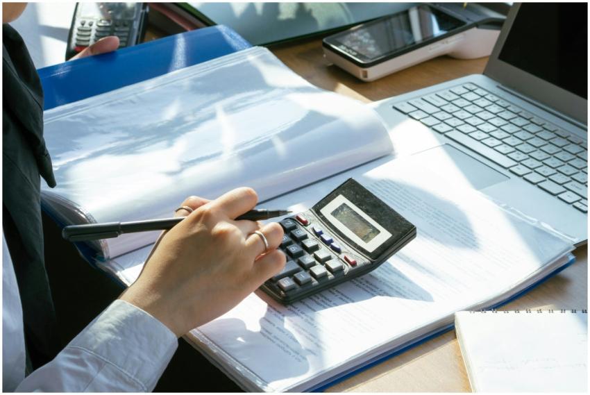 A person working on financial calculations using a