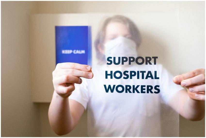 Person holding a support hospital workers sign, pr