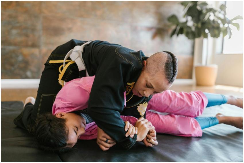 Instructor and student practicing martial arts tec