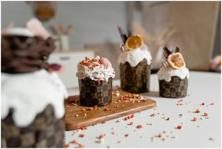 Decorative cupcakes topped with whipped cream and