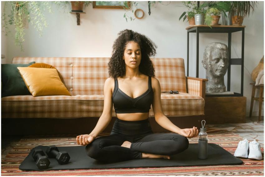 A woman meditating in a tranquil living room, embo