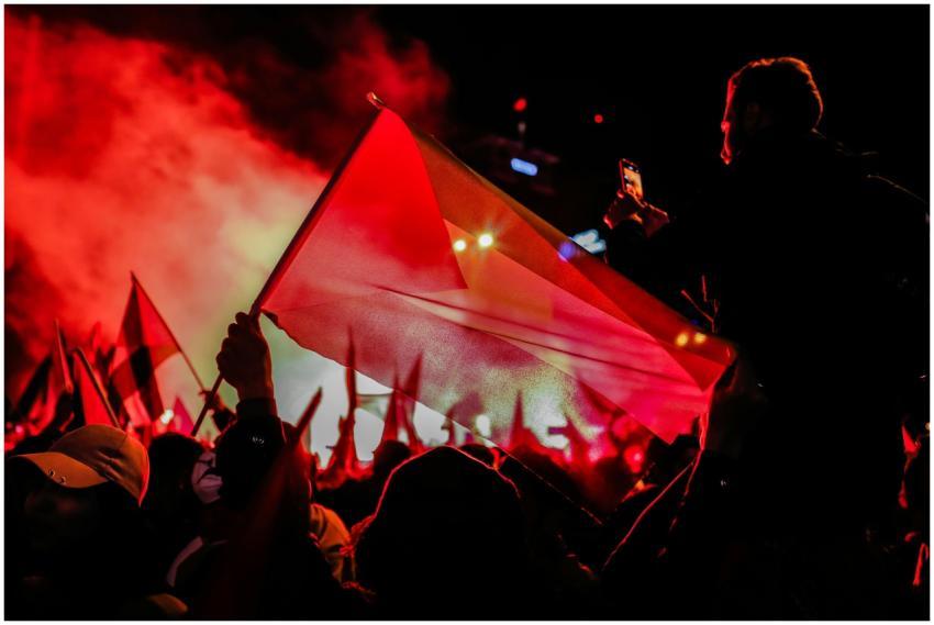 Nighttime protest showcasing vibrant red hues and