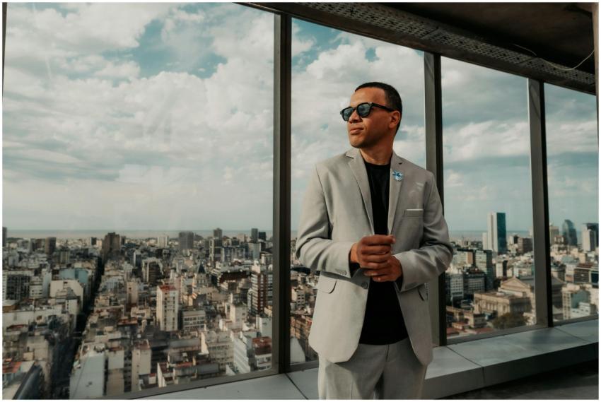 Confident businessman in a suit enjoys panoramic c