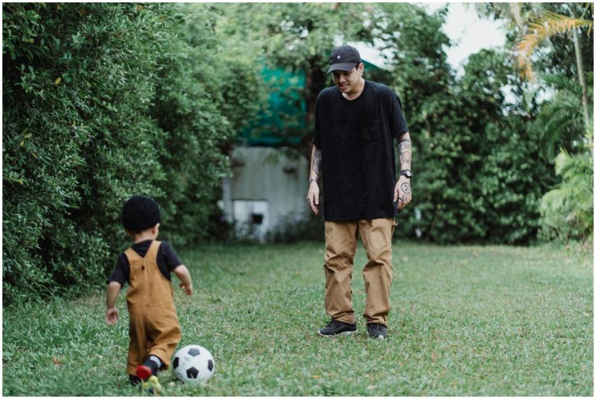 A father and young son enjoying soccer together on