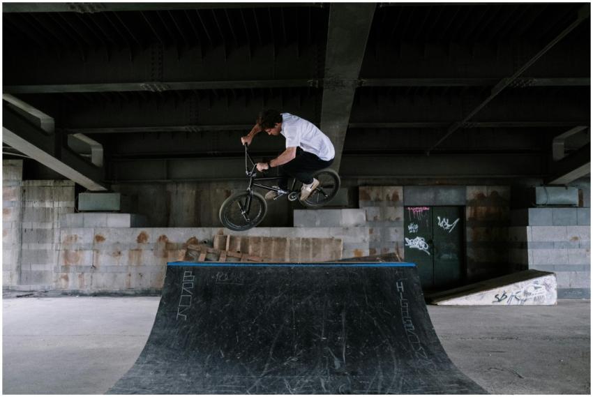 A BMX rider performs a high-flying trick at an urb