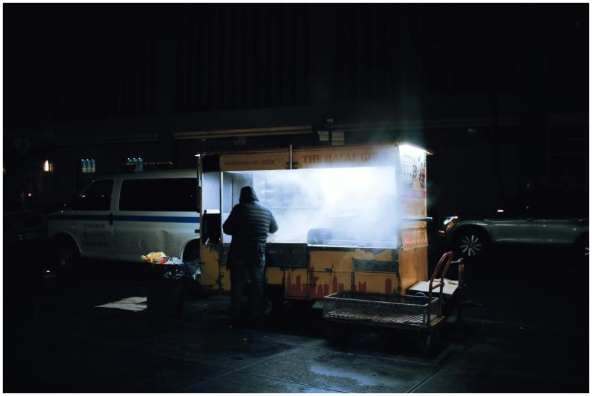 A street vendor prepares food at a night market wi