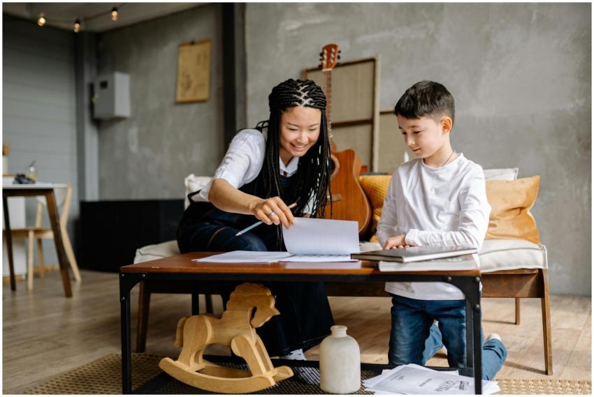 Asian woman and caucasian boy sitting on a couch,