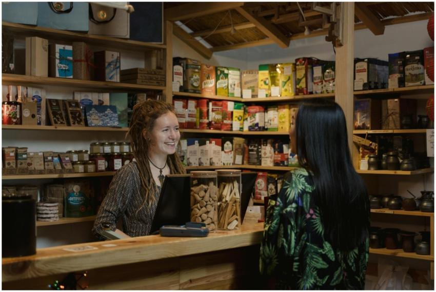 Friendly shopkeeper assisting a customer in a cozy