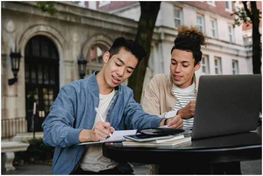 Two students working together on a project with a