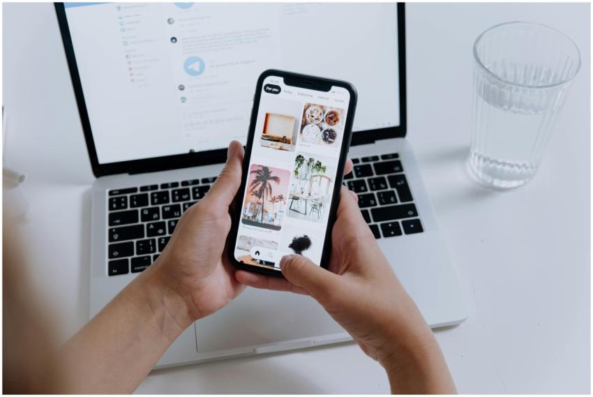 Hands holding a smartphone showcasing a gallery, w