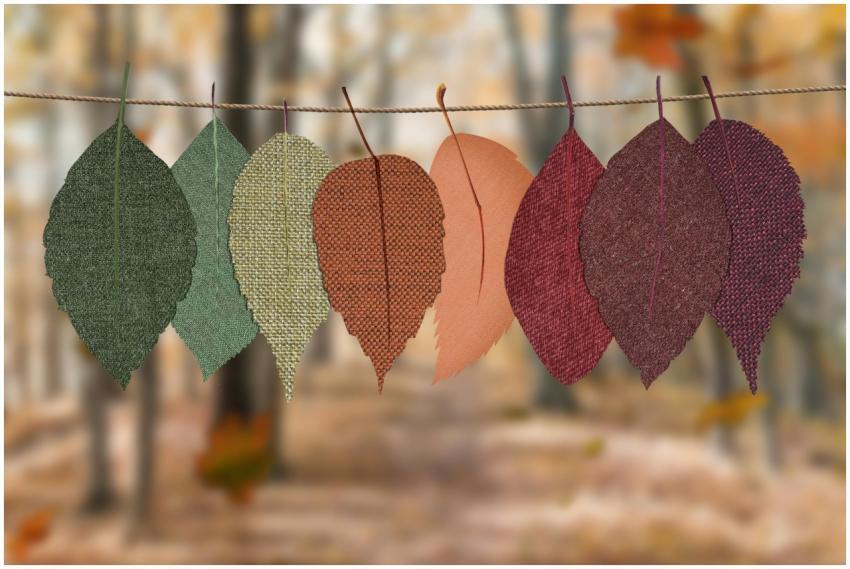 Fabric leaves hang on a rope, showcasing autumn co