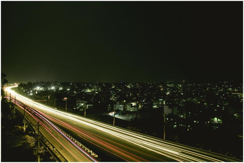 Nighttime highway with light trail effect, overloo