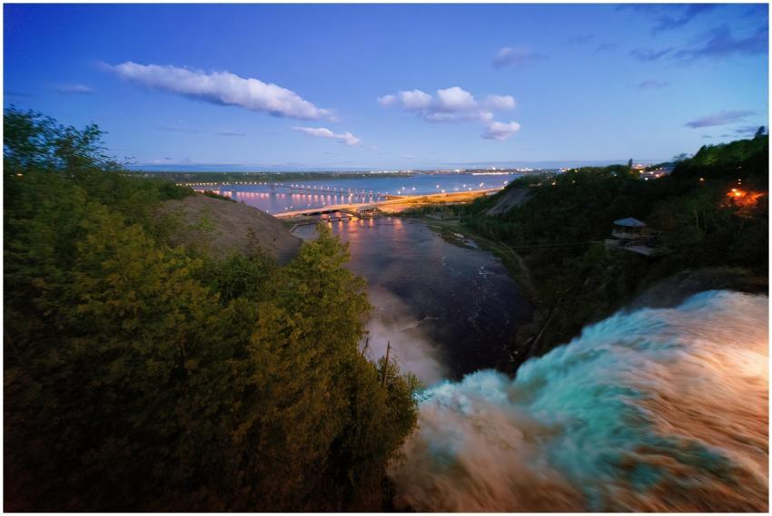 A breathtaking view of a waterfall with a distant