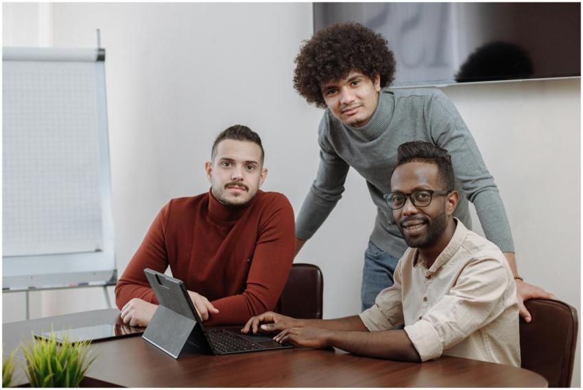 Three diverse team members working together on a p
