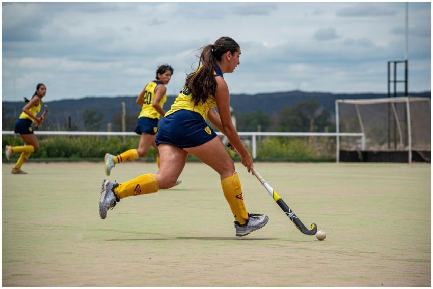 Women in action during an outdoor field hockey mat