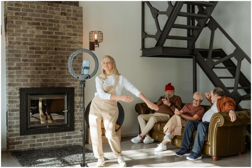 Elderly woman dances near smartphone while seniors