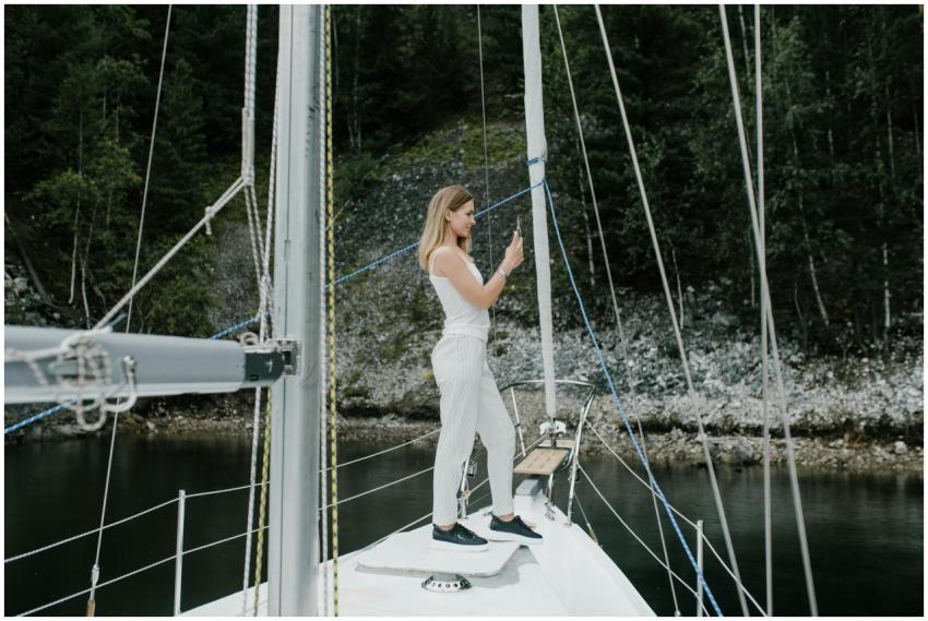 A woman stands on a yacht enjoying a tranquil outd