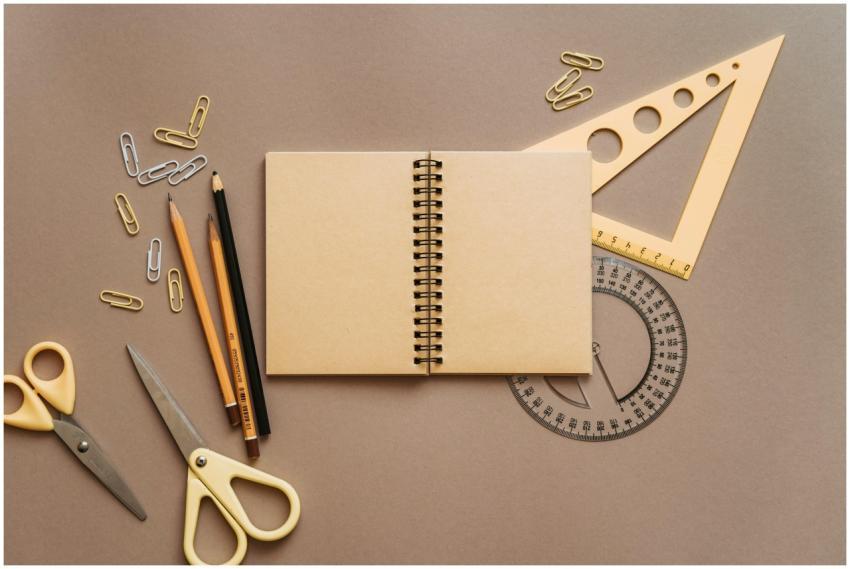 Flat lay of school supplies featuring a spiral not