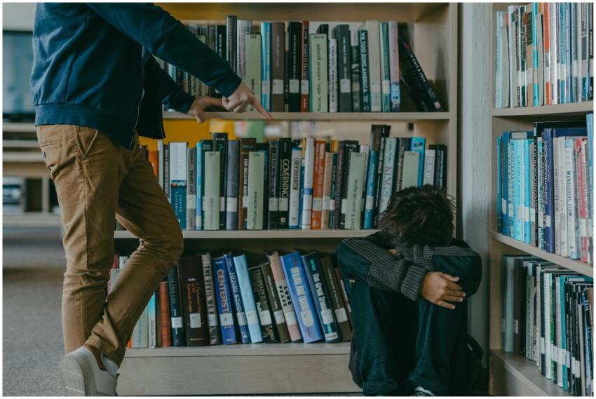 A child facing bullying while sitting in a library