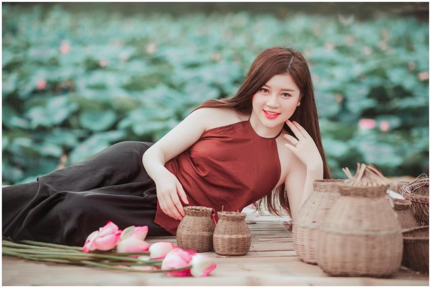 A young woman poses gracefully amidst baskets and