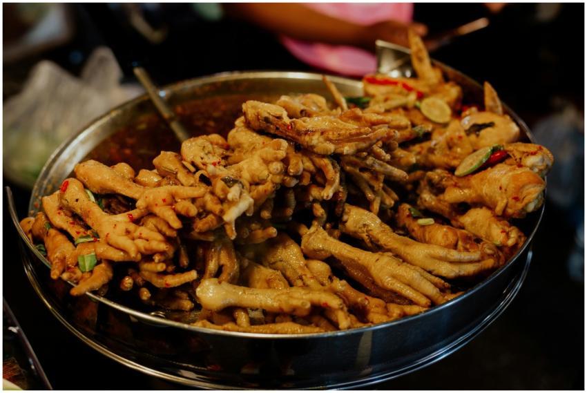 A close-up of spicy chicken feet served in a stree