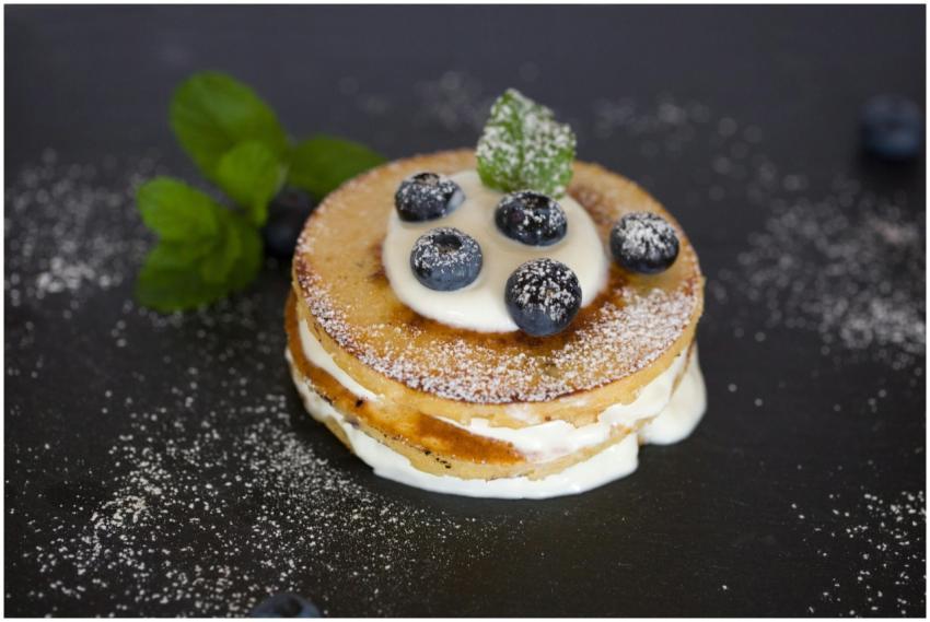 Close-up of a blueberry-topped pancake with cream