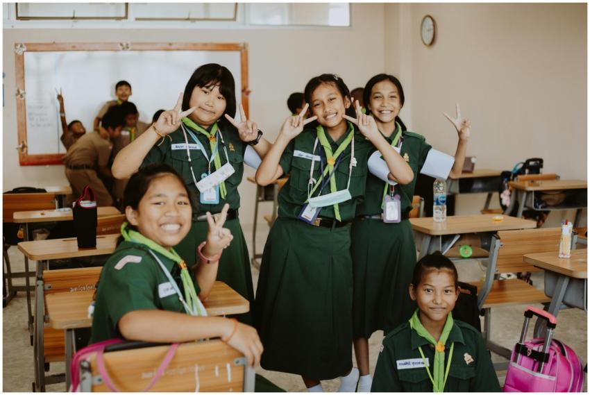 A group of joyful girl scouts posing happily in an