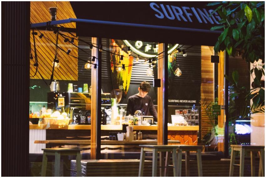 Warmly lit café interior with a barista preparing