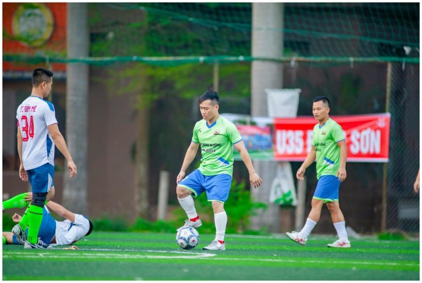 Amateur soccer players compete on a vibrant green