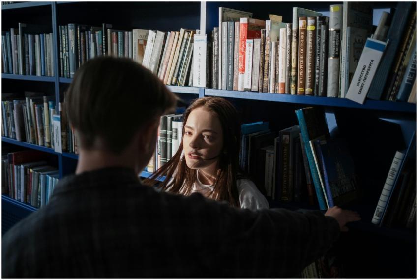 Teenagers having a conversation in a library with