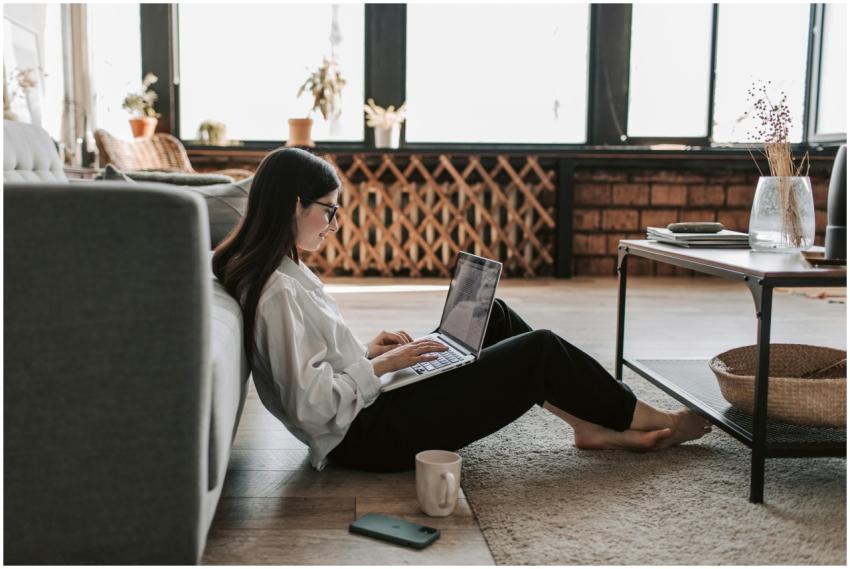 A young woman working from home using a laptop in