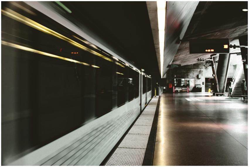 Subway station at night with a blurred train rushi