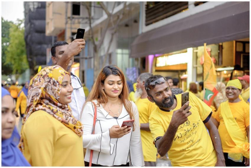 A lively street scene with a diverse group enjoyin