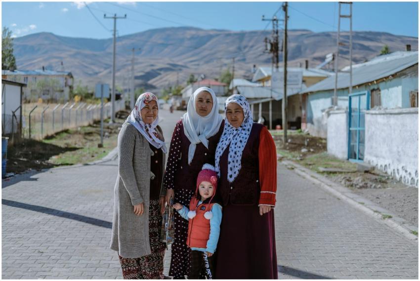 Women and child in traditional attire standing on