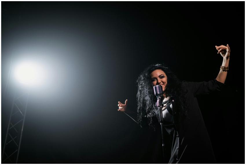 A vibrant female singer passionately performing un