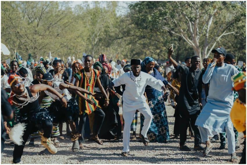 A lively outdoor gathering of African people engag