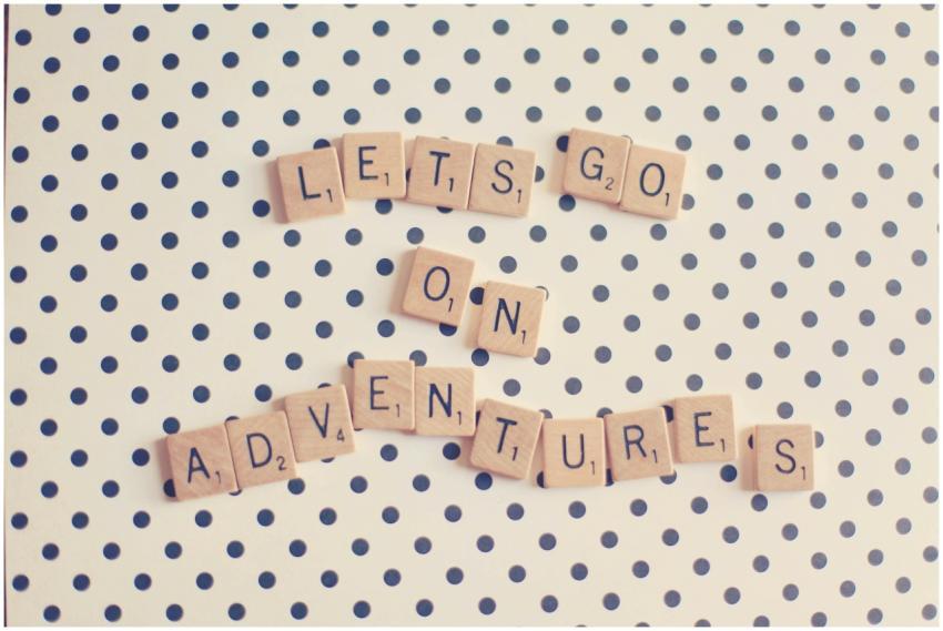 Scrabble tiles spell 'Let's go on adventures' on a