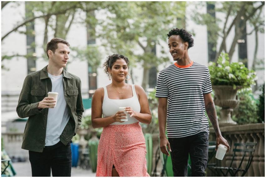 Stylish young multiracial students with cups of ta