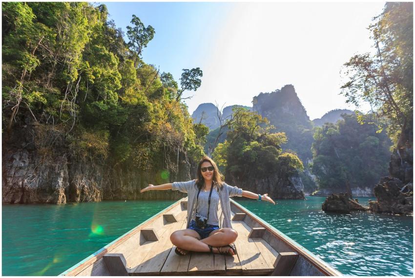 Asian woman relishing a serene boat journey throug