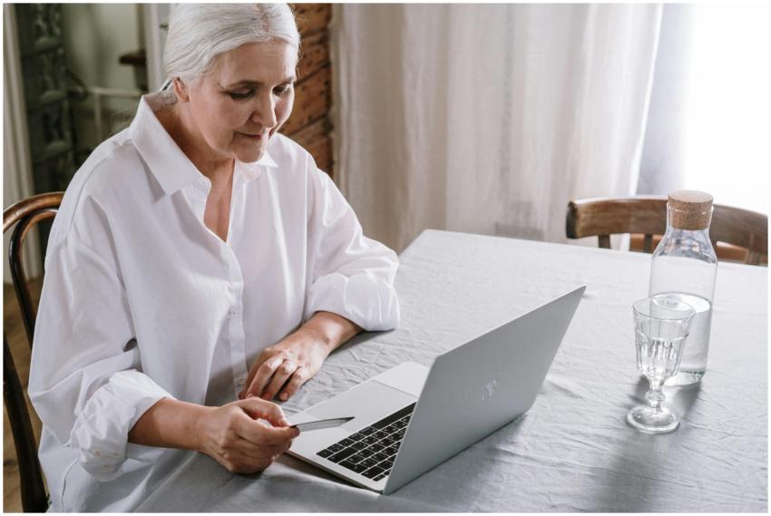 Elderly woman using laptop for online shopping at
