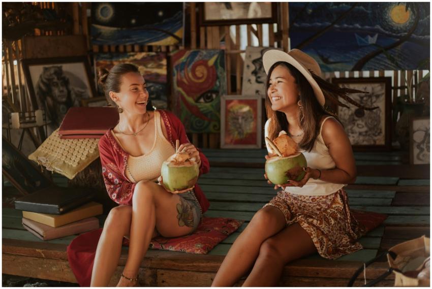 Two women laughing while enjoying refreshing cocon