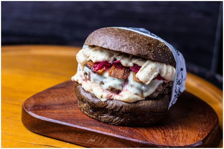 Mouth-watering gourmet burger with dark bun and me