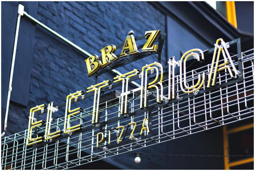 A vibrant neon sign displaying 'Elettrica' at a pi