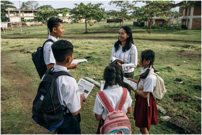 A group of students in school uniforms learning ou