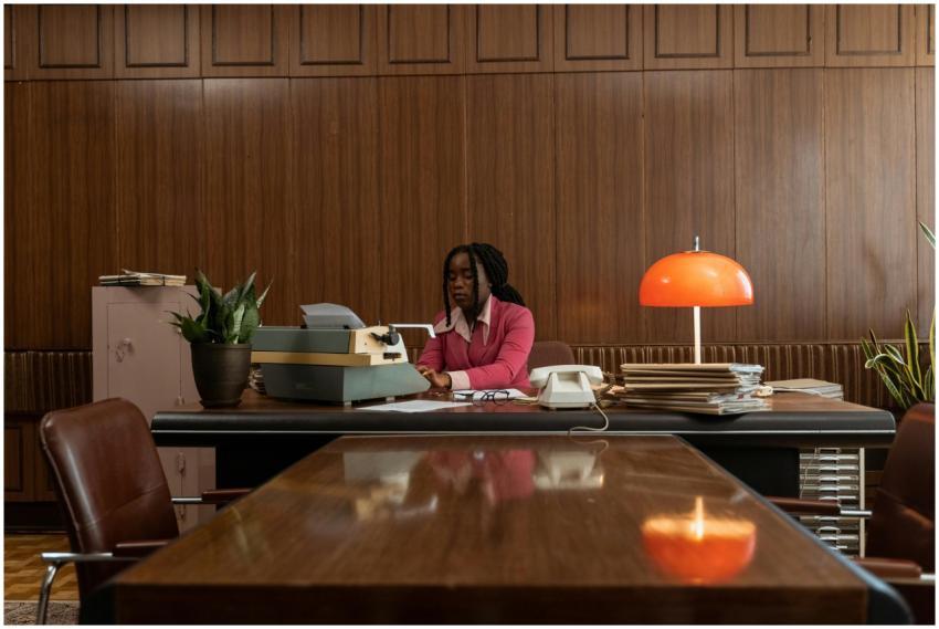 African American woman typing on an antique typewr